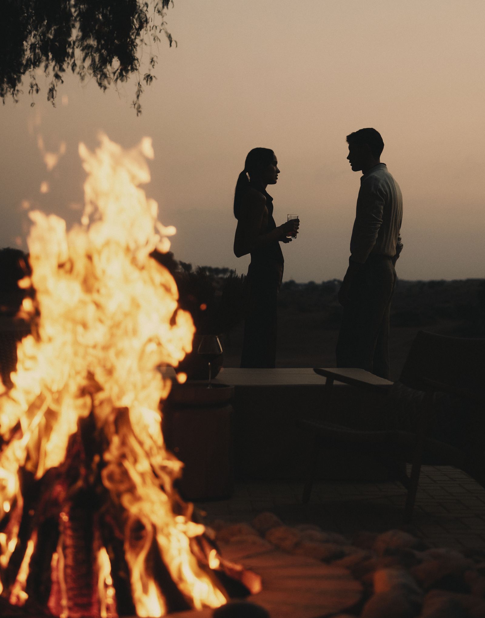 Residents beside a fire at dusk